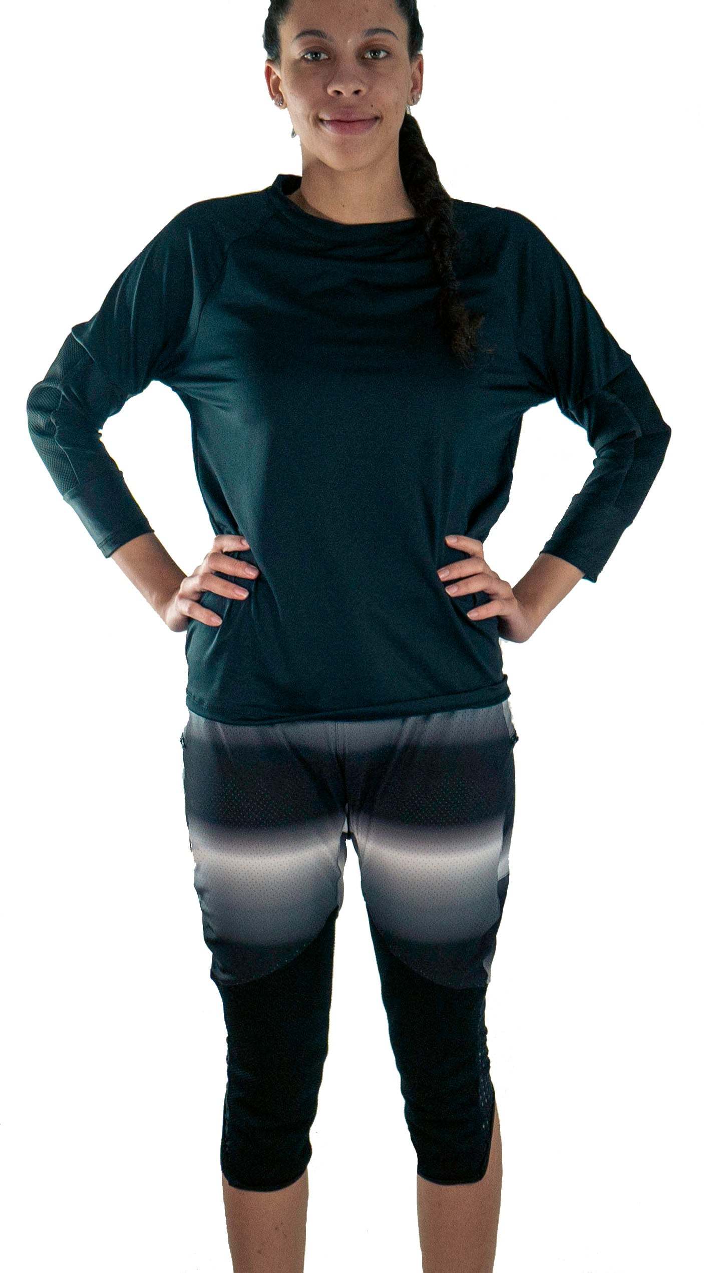 Woman wearing black long-sleeve shirt and knee-length bike pants with removable G-Form knee pads